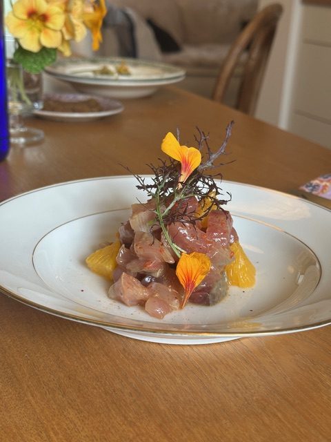 Fish crudo with citrus and nasturtium flowers